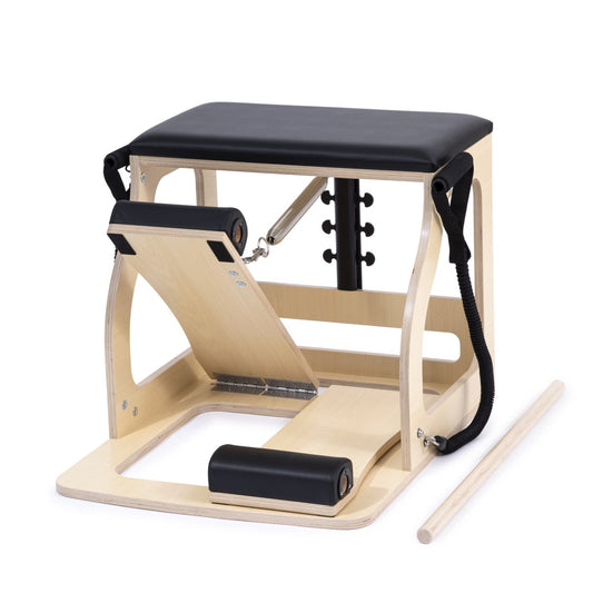Pilates reformer machine with wooden frame and black cushion on a white background